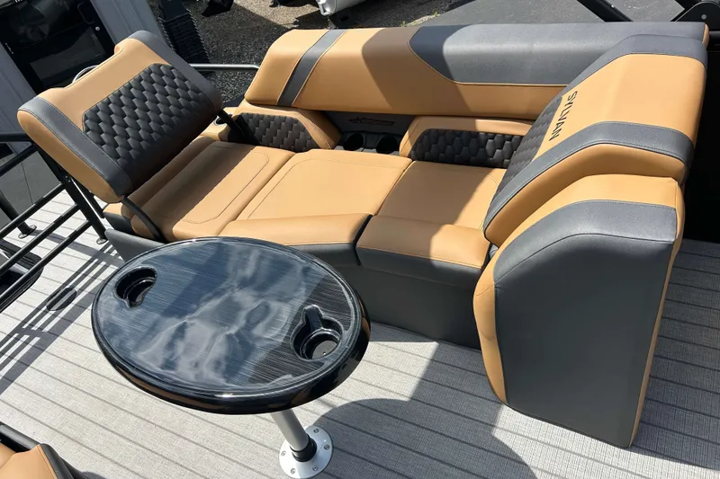 Slide: The Image of Luxurious seating on 2027 Sylvan X3 LZ DH Tritoon with stylish table and cup holders. - 6