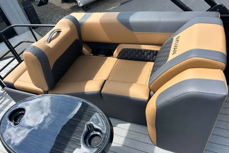 Slide: The Image of Luxurious seating on 2027 Sylvan X3 LZ DH Tritoon with stylish table and cup holders. - 7