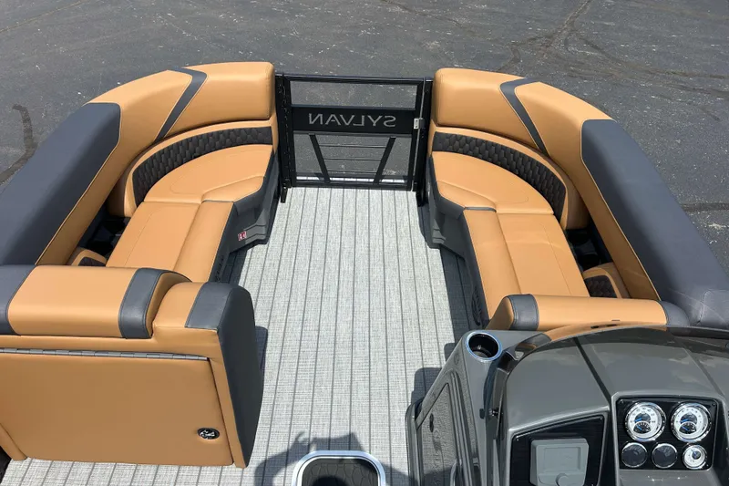 Slide: The Image of 2027 Sylvan X3 LZ DH Tritoon with tan and gray seating, modern dashboard. - 18