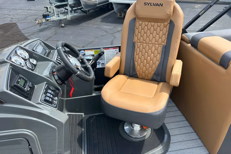 Slide: The Image of Captain's chair and dashboard of 2027 Sylvan X3 LZ DH Tritoon boat. - 10