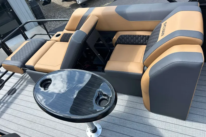 Slide: The Image of Luxurious seating on 2027 Sylvan X3 LZ DH Tritoon with sleek table and cup holders. - 8