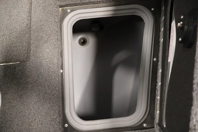 Slide: The Image of Storage compartment in 2025 Tracker Targa 18 WT boat, featuring a gray interior. - 18