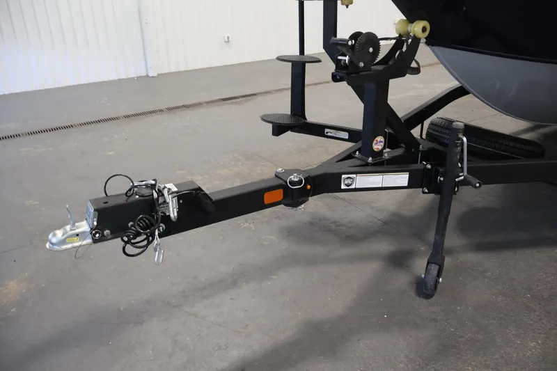 Slide: The Image of Trailer hitch of 2025 Tracker Targa 18 WT boat in a garage setting. - 49