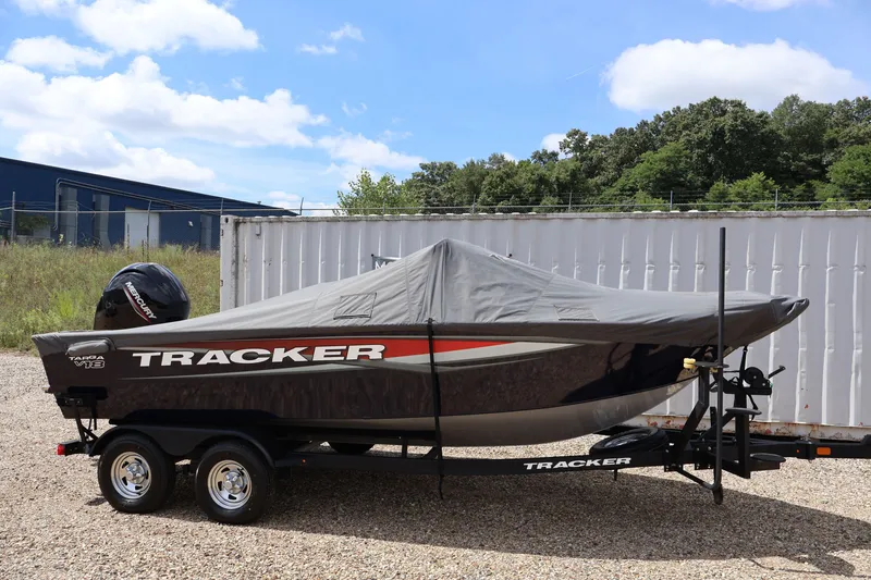 Slide: The Image of 2025 Tracker Targa 18 WT boat covered on trailer, outdoors. - 54