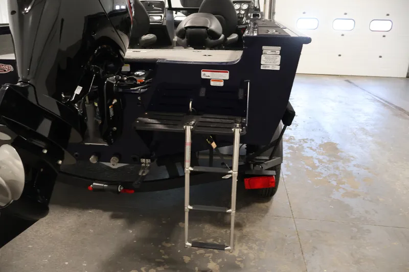 Slide: The Image of 2025 Tracker Targa 18 WT boat with motor and ladder in a garage setting. - 45
