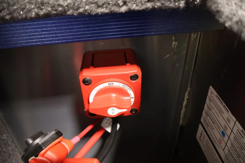 Slide: The Image of Red battery switch in 2025 Tracker Targa 18 WT boat interior. - 43