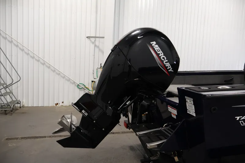 Slide: The Image of 2025 Tracker Targa 18 WT boat with Mercury outboard motor in a garage setting. - 46