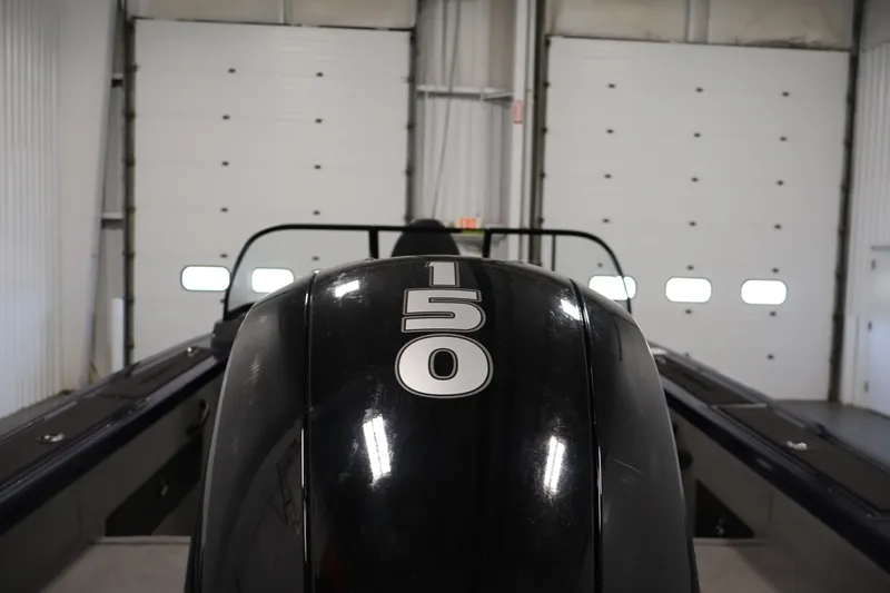 Slide: The Image of 2025 Tracker Targa 18 WT boat with 150 horsepower engine in a garage setting. - 47