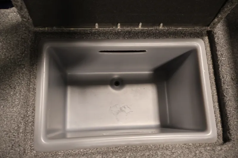 Slide: The Image of Empty storage compartment in a 2025 Tracker Targa 18 WT boat. - 44