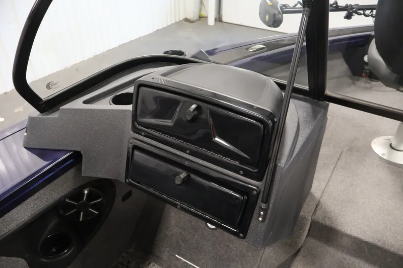 Slide: The Image of 2025 Tracker Targa 18 WT boat dashboard with storage compartments and speaker. - 33