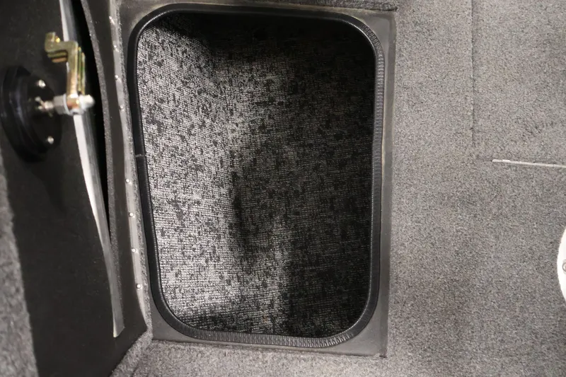 Slide: The Image of Storage compartment in 2025 Tracker Targa 18 WT boat, featuring carpeted interior. - 15