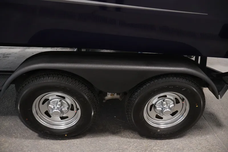 Slide: The Image of Trailer wheels of 2025 Tracker Targa 18 WT boat, featuring dual tires and fender. - 53