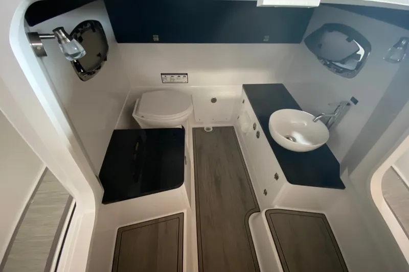 Slide: The Image of Luxurious bathroom interior of 2027 Monterey Elite 25 OB boat, featuring modern fixtures. - 18