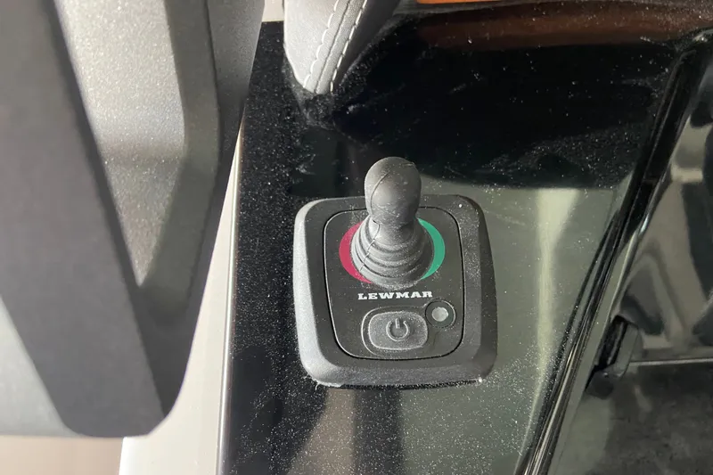 Slide: The Image of Joystick control on 2027 Monterey Elite 25 OB boat dashboard. - 13