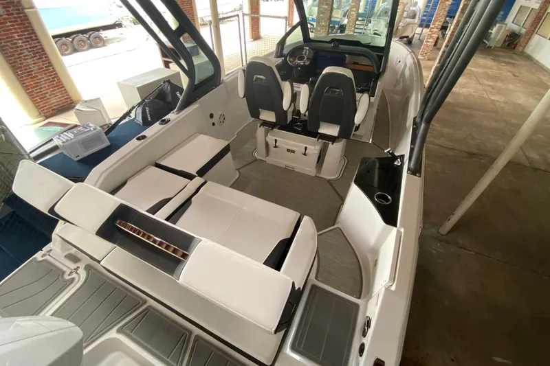 Slide: The Image of 2027 Monterey Elite 25 OB boat interior with seating and steering area. - 2