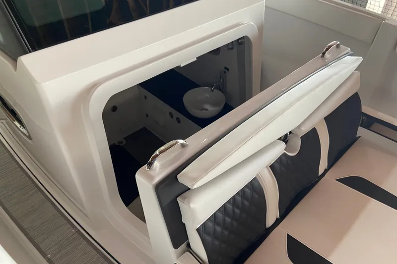 Slide: The Image of Interior view of 2027 Monterey Elite 25 OB boat, featuring seating and compact sink area. - 17
