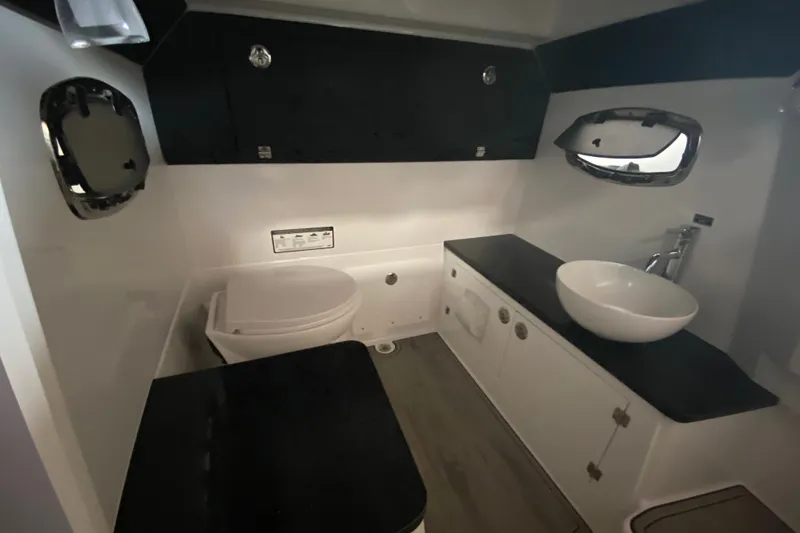 Slide: The Image of Luxurious bathroom interior of 2027 Monterey Elite 25 OB boat, featuring modern fixtures. - 19