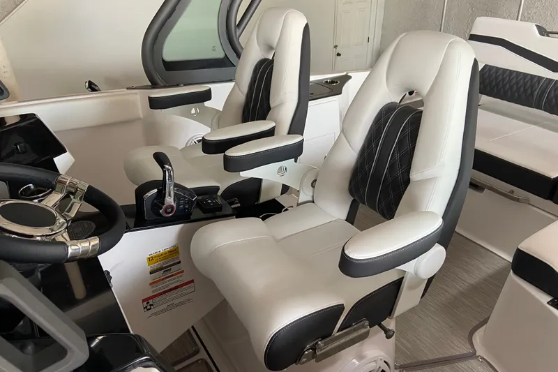 Slide: The Image of Luxury seating in 2027 Monterey Elite 25 OB boat cockpit, featuring modern design and controls. - 10