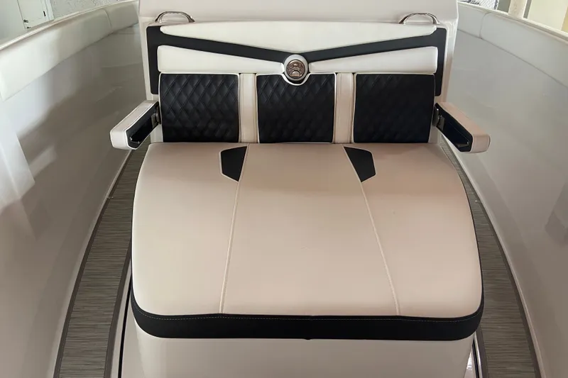 Slide: The Image of Luxury seating on 2027 Monterey Elite 25 OB boat, featuring elegant black and white upholstery. - 16