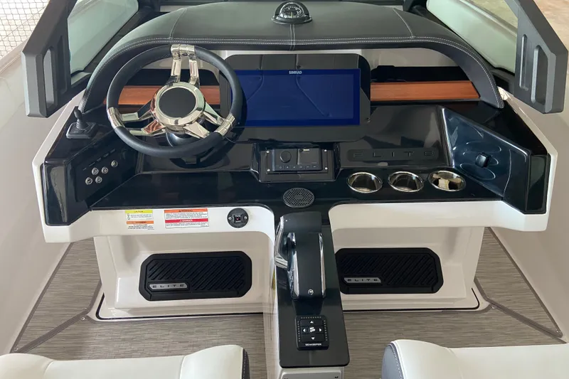 Slide: The Image of Cockpit of 2027 Monterey Elite 25 OB boat with modern steering and controls. - 12