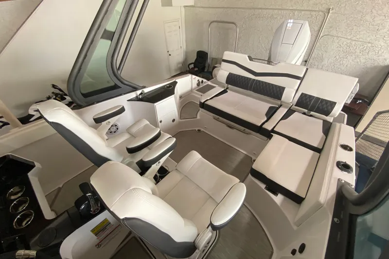 Slide: The Image of Interior of 2027 Monterey Elite 25 OB boat with luxurious white seating. - 11