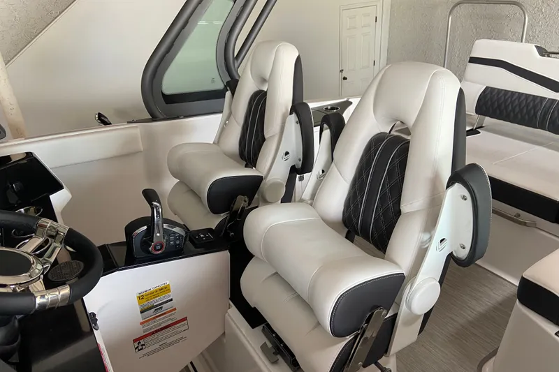 Slide: The Image of Luxury seating in 2027 Monterey Elite 25 OB boat cockpit, featuring modern design and controls. - 9