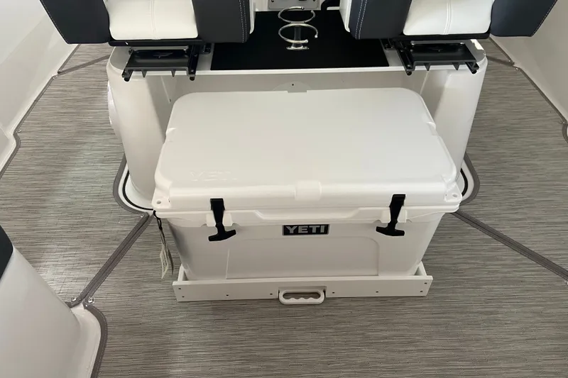 Slide: The Image of YETI cooler on 2027 Monterey Elite 25 OB boat with stylish seating. - 8