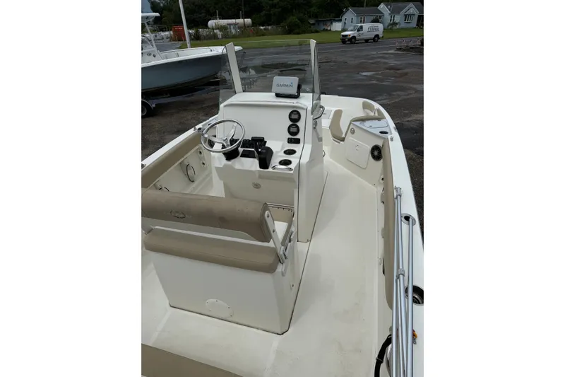 Slide: The Image of 2019 Stingray 206 CC boat interior with steering console and seating. - 6