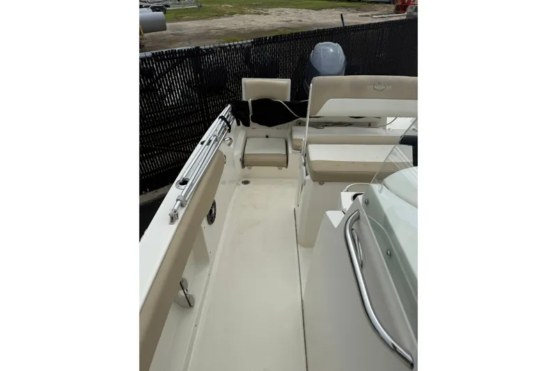 Slide: The Image of 2019 Stingray 206 CC boat interior with beige seating and stainless steel railings. - 8