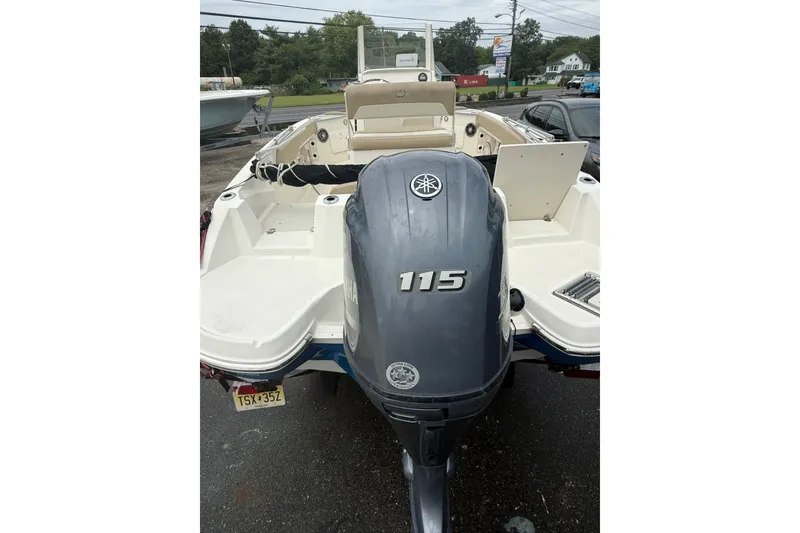 Slide: The Image of 2019 Stingray 206 CC boat with Yamaha 115 outboard motor, parked outdoors. - 4