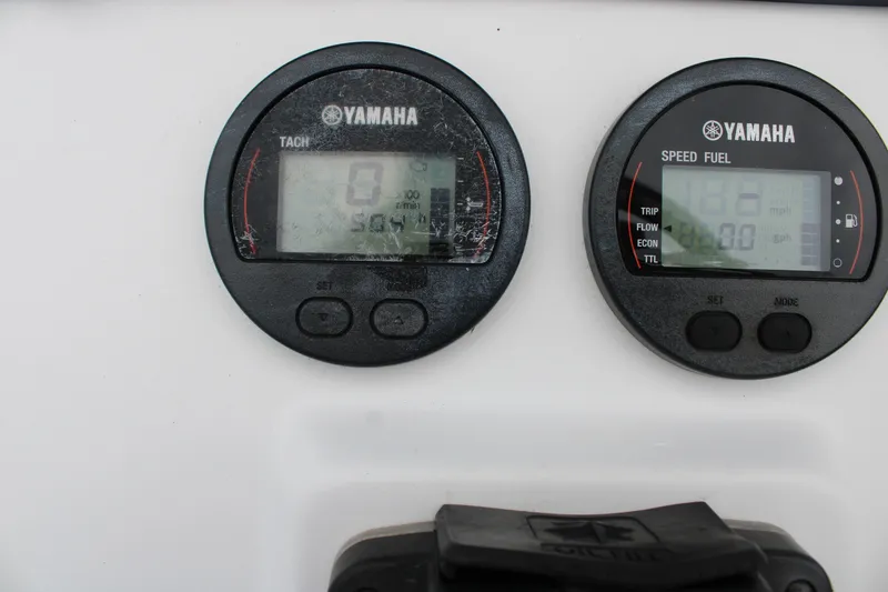 Slide: The Image of Yamaha tachometer and speed fuel gauges on 2018 Sea Hunt BX21 boat dashboard. - 23