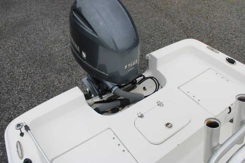 Slide: The Image of 2018 Sea Hunt BX21 boat with Yamaha 150 outboard motor on a textured surface. - 11