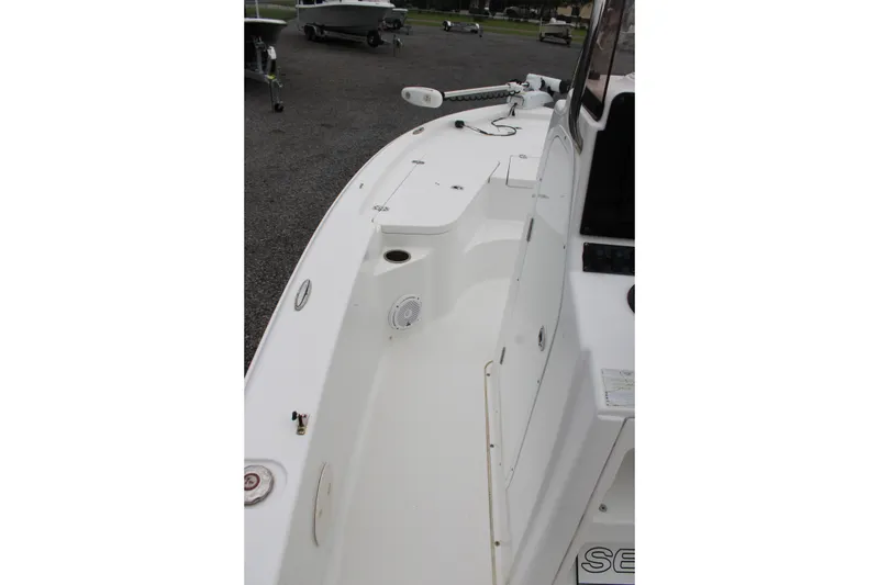 Slide: The Image of 2018 Sea Hunt BX21 boat deck, featuring clean white surface and storage compartments. - 24