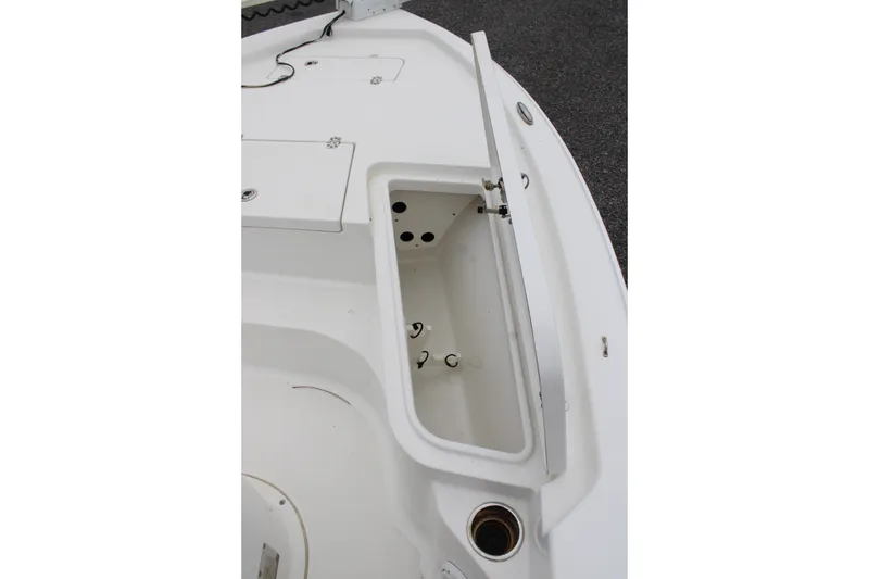 Slide: The Image of 2018 Sea Hunt BX21 boat storage compartment with open hatch, showcasing interior design. - 16