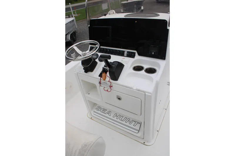 Slide: The Image of 2018 Sea Hunt BX21 boat console with steering wheel and controls. - 14