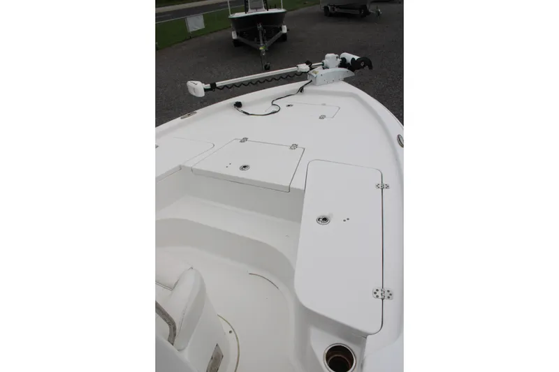 Slide: The Image of 2018 Sea Hunt BX21 boat deck with storage compartments and trolling motor. - 15