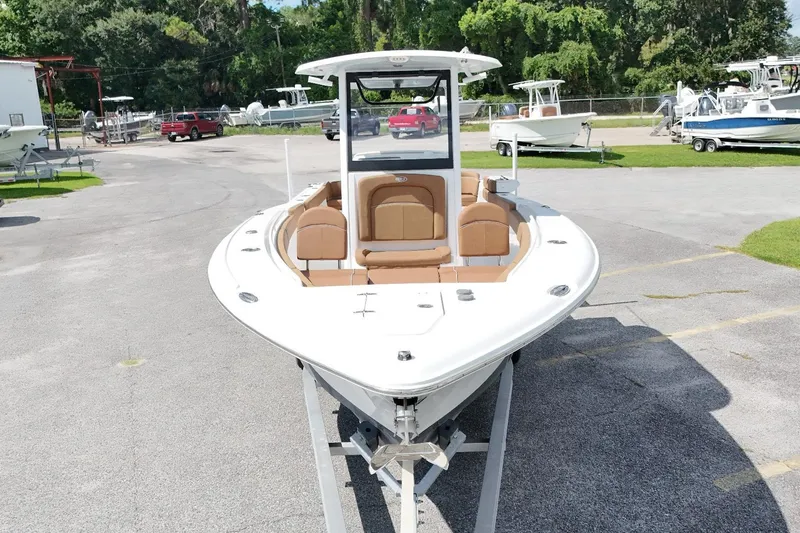 Slide: The Image of 2023 Sea Hunt Ultra 275SE boat on display at a marina. - 14