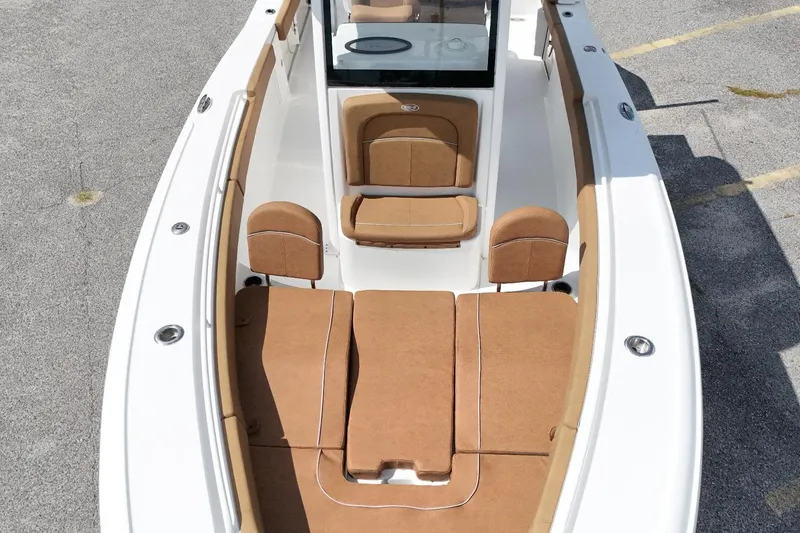 Slide: The Image of 2023 Sea Hunt Ultra 275SE boat with tan seating and white deck. - 13