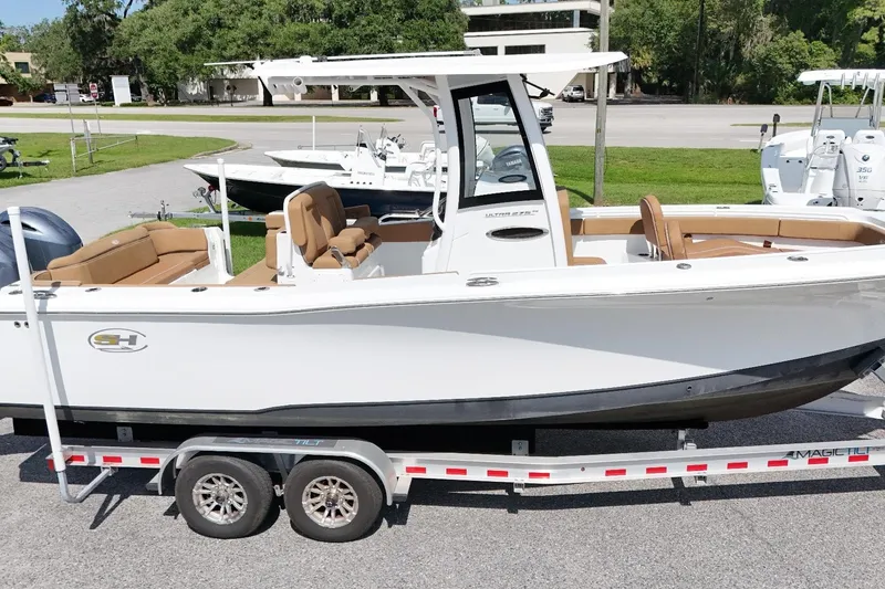 Slide: The Image of 2023 Sea Hunt Ultra 275SE boat on trailer, featuring sleek design and spacious seating. - 15