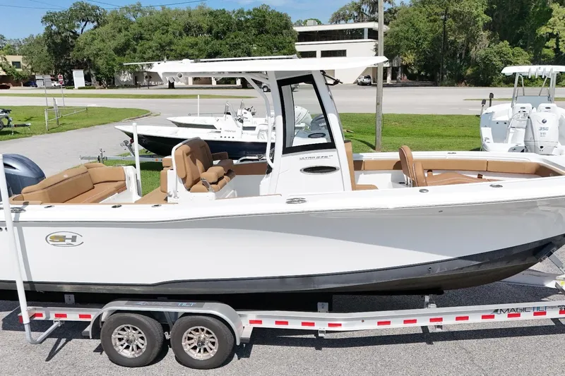 The Image of 2023 Sea Hunt Ultra 275SE boat on trailer, featuring sleek design and spacious seating. - 0
