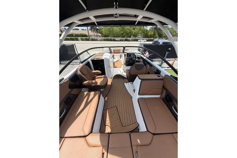 Slide: The Image of 2025 Yamaha 252 SD boat interior with tan seating and sleek design. - 20