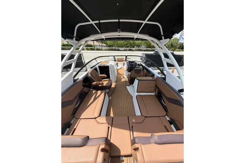 Slide: The Image of 2025 Yamaha 252 SD boat interior with tan seating and sleek design. - 15