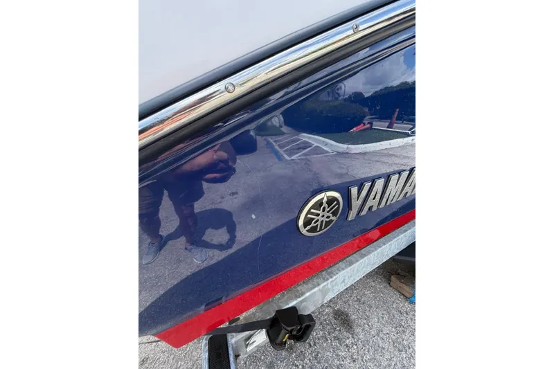 Slide: The Image of 2025 Yamaha 252 SD boat side view with logo and reflection. - 19