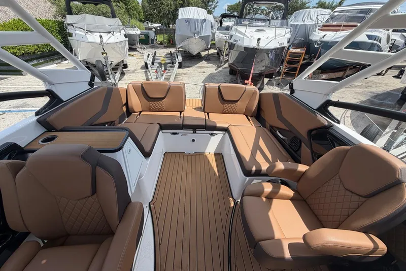 Slide: The Image of Luxurious interior of 2025 Yamaha 252 SD boat with tan leather seating and wood flooring. - 14