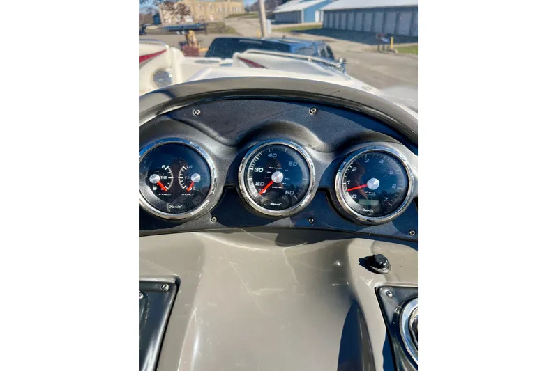 Slide: The Image of Dashboard of a 2013 Hurricane SunDeck 2200 OB boat with gauges and controls. - 18