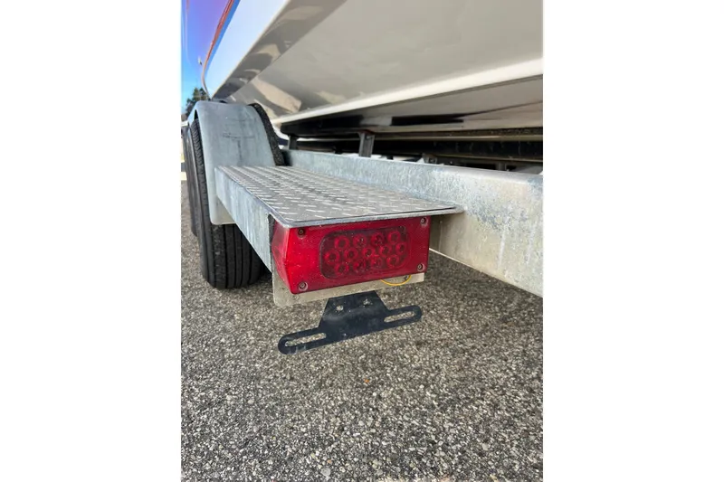 Slide: The Image of Trailer light and fender of 2013 Hurricane SunDeck 2200 OB boat on pavement. - 67