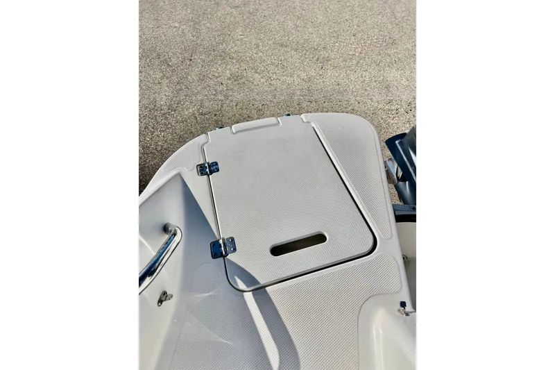 Slide: The Image of 2013 Hurricane SunDeck 2200 OB boat deck with storage compartment and textured surface. - 41