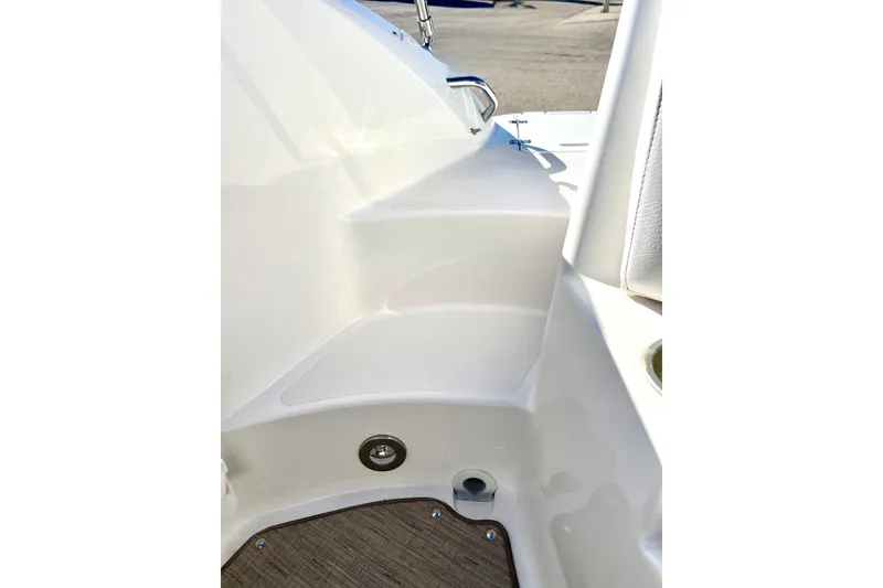 Slide: The Image of 2013 Hurricane SunDeck 2200 OB boat interior detail with white seating and flooring. - 23