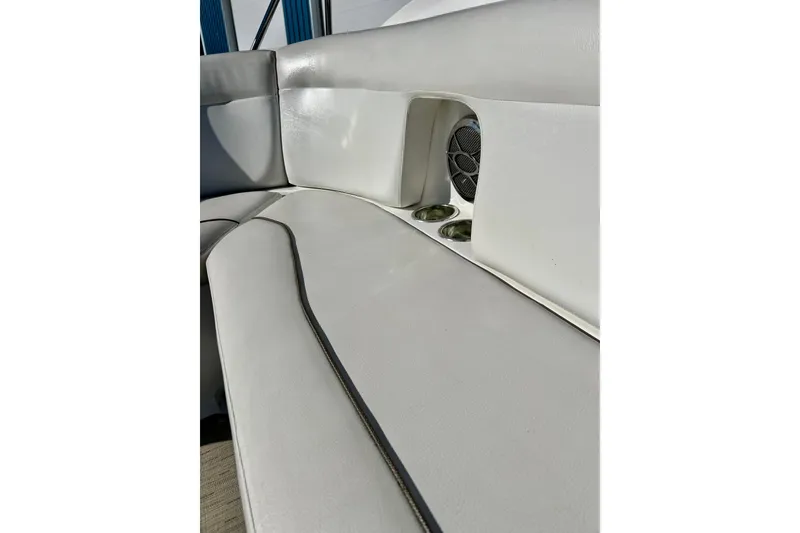Slide: The Image of 2013 Hurricane SunDeck 2200 OB boat interior with white seating and built-in speaker. - 61
