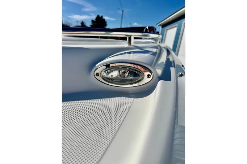 Slide: The Image of Close-up of a 2013 Hurricane SunDeck 2200 OB boat's deck light under a clear blue sky. - 71